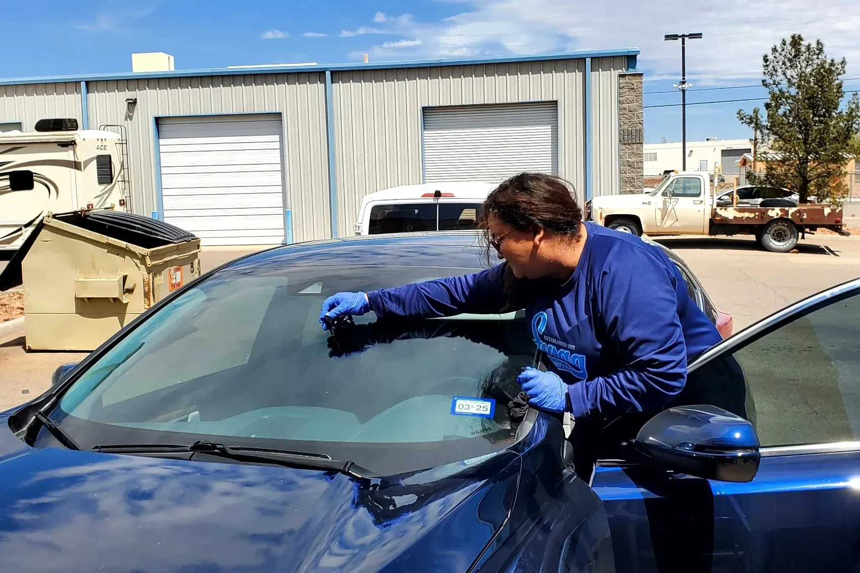 Resin being injected into a windshield rock chip during a mobile repair in Las Vegas